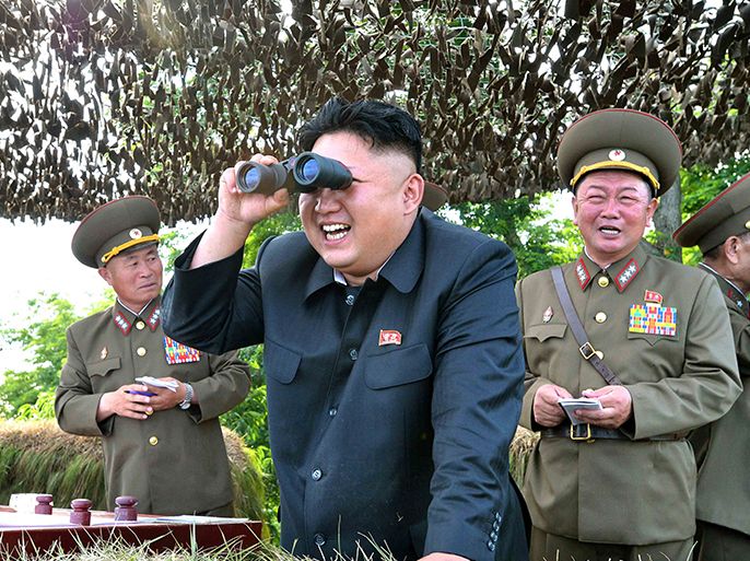 North Korean leader Kim Jong Un looks through a pair of binoculars during an inspection of the Hwa Islet Defence Detachment standing guard over a forward post off the east coast of the Korean peninsula, in this undated photo released by North Korea's Korean Central News Agency (KCNA) in Pyongyang on July 1, 2014. REUTERS/KCNA (NORTH KOREA - Tags: POLITICS MILITARY MARITIME TPX IMAGES OF THE DAY) ATTENTION EDITORS ? THIS PICTURE WAS PROVIDED BY A THIRD PARTY. REUTERS IS UNABLE TO INDEPENDENTLY VERIFY THE AUTHENTICITY, CONTENT, LOCATION OR DATE OF THIS IMAGE. FOR EDITORIAL USE ONLY. NOT FOR SALE FOR MARKETING OR ADVERTISING CAMPAIGNS. NO THIRD PARTY SALES. NOT FOR USE BY REUTERS THIRD PARTY DISTRIBUTORS. SOUTH KOREA OUT. NO COMMERCIAL OR EDITORIAL SALES IN SOUTH KOREA. THIS PICTURE IS DISTRIBUTED EXACTLY AS RECEIVED BY REUTERS, AS A SERVICE TO CLIENTS
