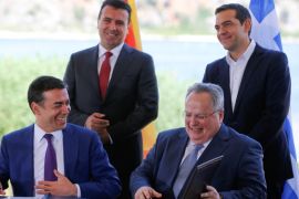 Greek Foreign Minister Nikos Kotzias and his Macedonian counterpart Nikola Dimitrov sign an accord to settle a long dispute over the former Yugoslav republic's name as Greek Prime Minister Alexis Tsipras and Macedonian Prime Minister Zoran Zaev look on in the village of Psarades, in Prespes, Greece, June 17, 2018. REUTERS/Alkis Konstantinidis TPX IMAGES OF THE DAY