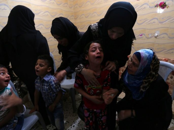 A relative of a Palestinian, who died of wounds he sustained during a protest at the Israel-Gaza border, mourns during his funeral in the southern Gaza Strip May 30, 2018. REUTERS/Ibraheem Abu Mustafa