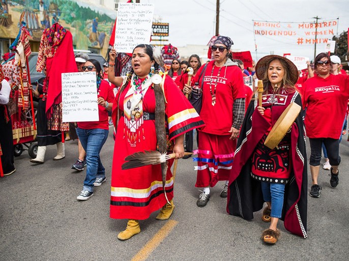 Roxanne White, center, leads a march through downtown Toppenish, Wash., wearing red to bring awareness to missing and murdered Indigenous women on May 5, 2018.