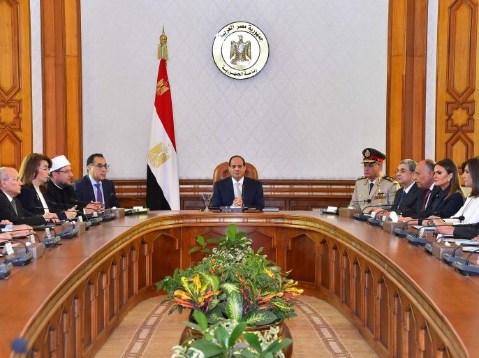 Egyptian President Abdel Fattah al-Sisi (C) and Mustafa Madbouly (6th L), newly appointed Prime Minister attend the first meeting after Egypt appointed a new government on Thursday at the Ittihadiya presidential palace in Cairo, Egypt, June 14, 2018, in this handout picture courtesy of the Egyptian Presidency. The Egyptian Presidency/Handout via REUTERS ATTENTION EDITORS - THIS IMAGE WAS PROVIDED BY A THIRD PARTY