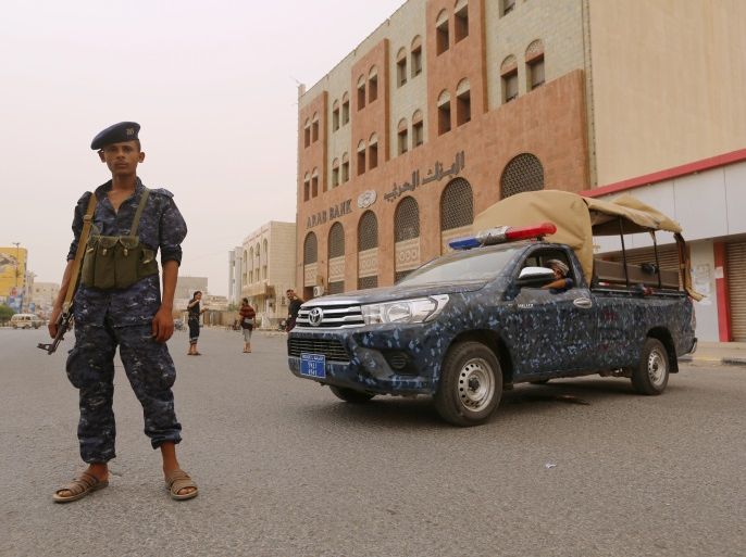 A pro-Houthi police trooper stands past a patrol vehicle in the Red Sea port city of Hodeidah, Yemen June 14, 2018. REUTERS/Abduljabbar Zeyad