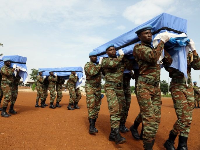 U.N. peacekeepers carry the coffins of the three United Nations soldiers from Bangladesh, who were killed by an explosive device in northern Mali on Sunday, during a ceremony at the MINUSMA base in Bamako, Mali September 27, 2017. REUTERS/Moustapha Diallo