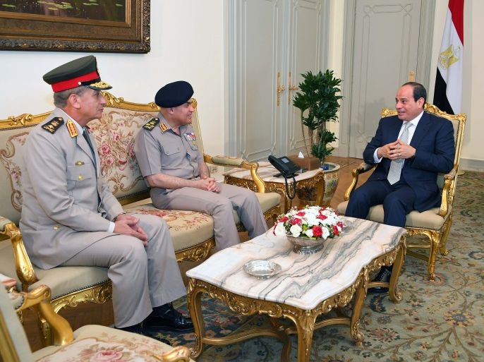 Egyptian President Abdel Fattah al-Sisi (R) meets with his newly appointed Defense Minister General Mohamed Ahmed Zaki (L ) and former defense minister Sedki Sobhi (C) after Egypt appointed a new government on Thursday at the Ittihadiya presidential palace in Cairo, Egypt, June 14, 2018 in this handout picture courtesy of the Egyptian Presidency. The Egyptian Presidency/Handout via REUTERS ATTENTION EDITORS - THIS IMAGE WAS PROVIDED BY A THIRD PARTY