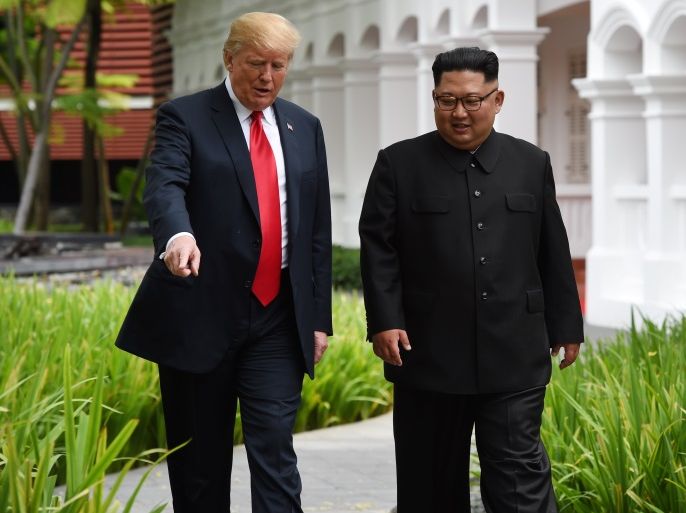 U.S. President Donald Trump and North Korean leader Kim Jong Un walk in the Capella Hotel after their working lunch, on Sentosa island in Singapore June 12, 2018. Anthony Wallace/Pool via Reuters