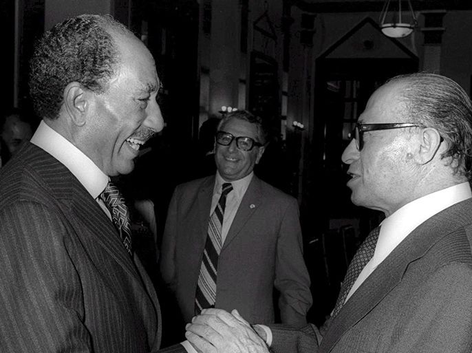 epa01175958 (FILES) Photograph dated 19 November 1977 shows shows Egyptian President Anwar Sadat (L) and Israeli Prime Minister Menachem Begin (R) as they talk while grasping hands in the King David Hotel during Sadat's historic visit to Jerusalem thrity years ago. On the evening of 19 November 1977 Egyptian President Anwar Sadat walked, tense, stiff and apprehensive, on the red carpet Israeli Prime Minister Menachem Begin rolled out at Ben Gurion Airport for his long time adversary, a man who tried and almost succeeded to defeat Israel in a war four years earlier. EPA/YAACOV SAAR ISRAELI MEDIA MUST CREDIT GPO EDITORIAL USE ONLY