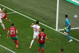 SAINT PETERSBURG, RUSSIA - JUNE 15: Aziz Bouhaddouz of Morocco scores an own goal for Iran's first goal during the 2018 FIFA World Cup Russia group B match between Morocco and Iran at Saint Petersburg Stadium on June 15, 2018 in Saint Petersburg, Russia. (Photo by Francois Nel/Getty Images)