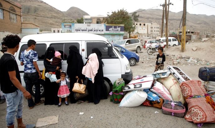 Displaced people from Hodeidah city stand next to their belongings near a school where displaced people live, in Sanaa, Yemen June 21, 2018.REUTERS/Mohamed al-Sayaghi?
