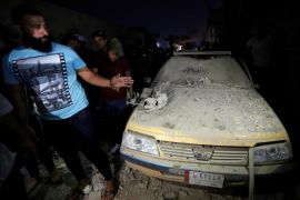 Civilians inspect the site of a car bomb attack in Sadr City district of Baghdad, Iraq June 6, 2018. REUTERS/Wissm al-Okili