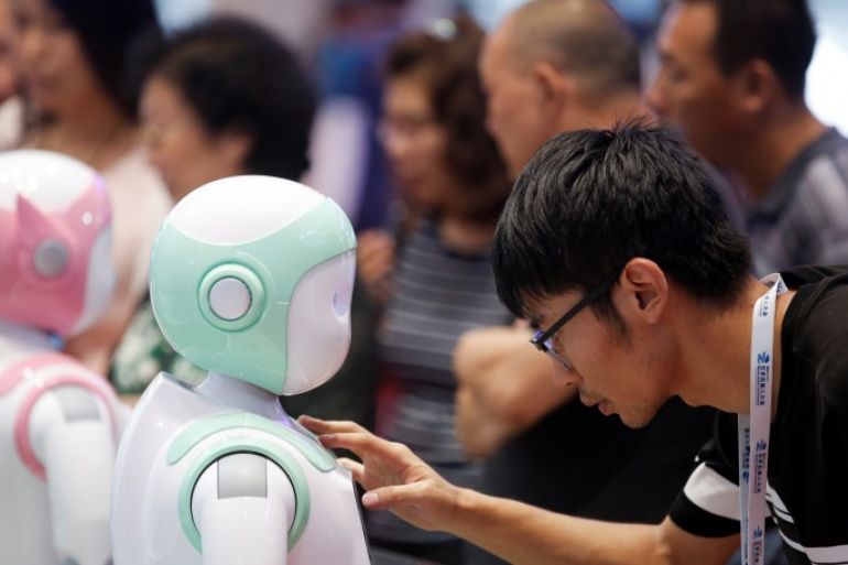 A man programs an iPal Companion Robot by Nanjing Avatar Mind Robot Technology at the 2017 World Robot conference in Beijing, China August 22, 2017. REUTERS/Thomas Peter
