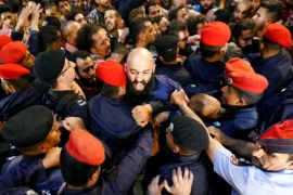 Policemen clash with protesters near the Jordan's Prime Minister's office in Amman