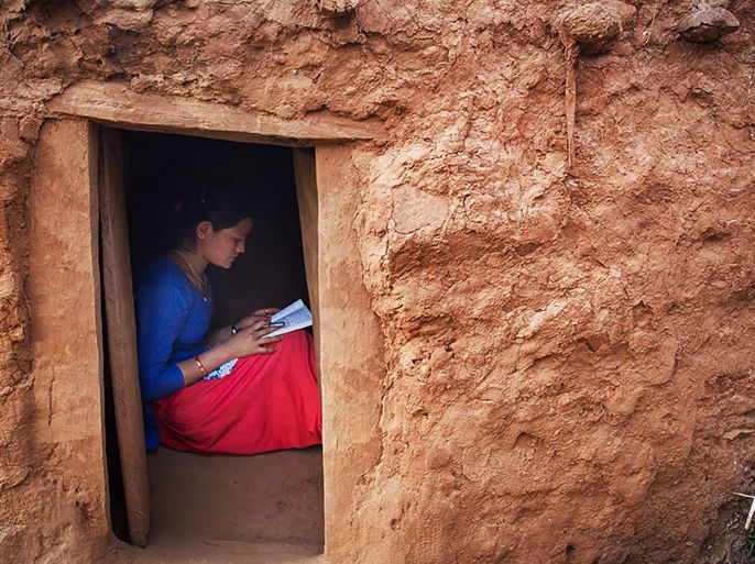 Kusum Thapa, 17, does her school work in her family’s chhaupadi hut, in the village of Dhungani.CreditTara Todras-Whitehill for The New York Times