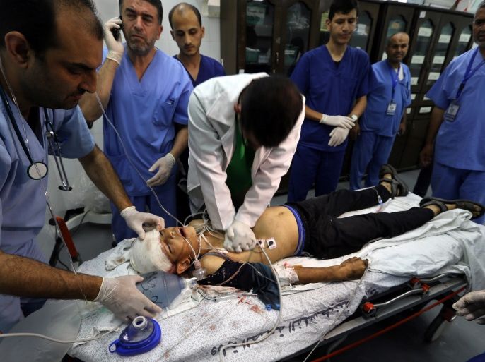 ATTENTION EDITORS - VISUAL COVERAGE OF SCENES OF INJURY OR DEATH Doctors and medics try to resuscitate 14-year-old Palestinian boy Yasser Abu Al-Naja, who died later after he was shot by Israeli forces during a protest at the Israel-Gaza border, at a hospital in the southern Gaza Strip June 29, 2018. REUTERS/Ibraheem Abu Mustafa TEMPLATE OUT