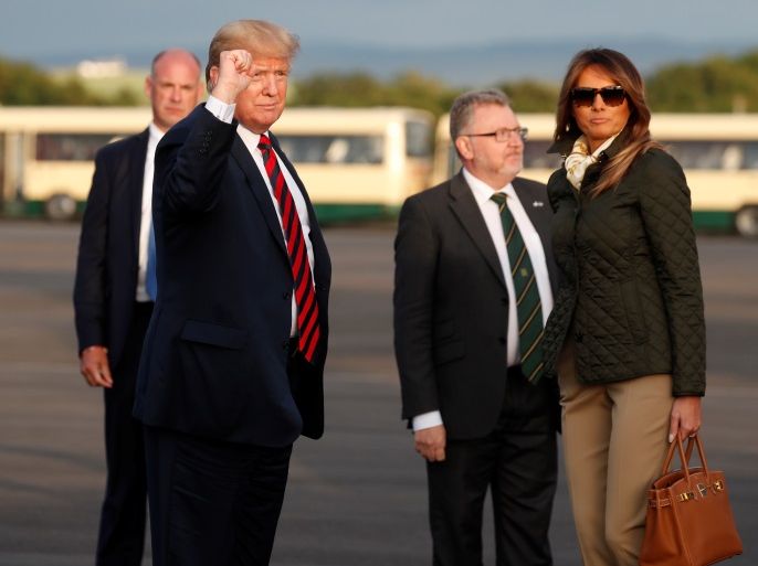 U.S. President Donald Trump pumps his fist as he and first lady Melania Trump arrive in Glasgow, Scotland, Britain July 13, 2018. REUTERS/Kevin Lamarque