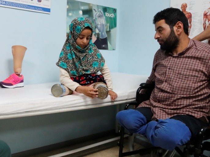 Maya Meri, 8, waits with her father Muhammed Ali Meri at a prosthetic center in Istanbul, Turkey, July 5, 2018. Picture taken July 5, 2018. REUTERS/Osman Orsal
