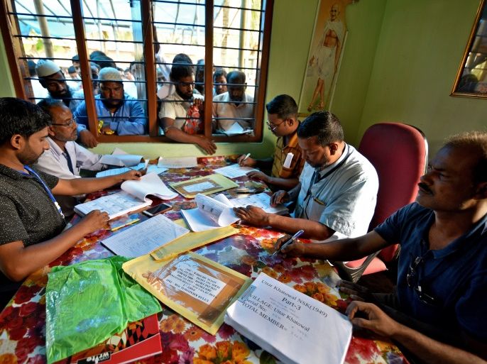 People wait to check their names on the draft list at the National Register of Citizens (NRC) centre at a village in Nagaon district, Assam state, India, July 30, 2018. REUTERS/Stringer
