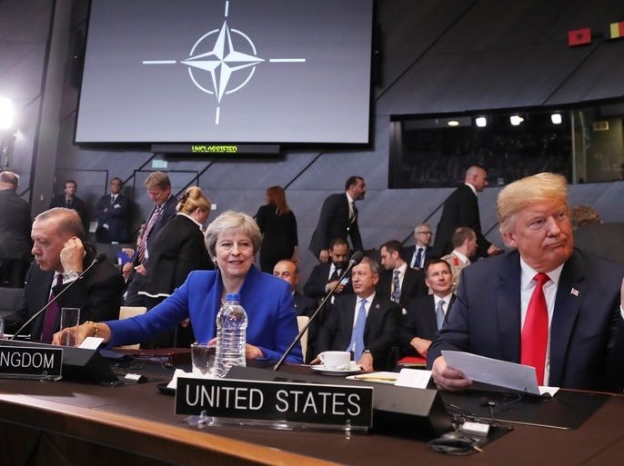 epaselect epa06880334 (L-R) Turkey's President Recep Tayyip Erdogan, British Prime Minister Theresa May and US President Donald J. Trump (C) before the start of the North Atlantic Council round table during a NATO summit in Brussels, Belgium, 11 July 2018. NATO countries' heads of states and governments gather in Brussels for a two-day meeting. EPA-EFE/OLIVIER HOSLET