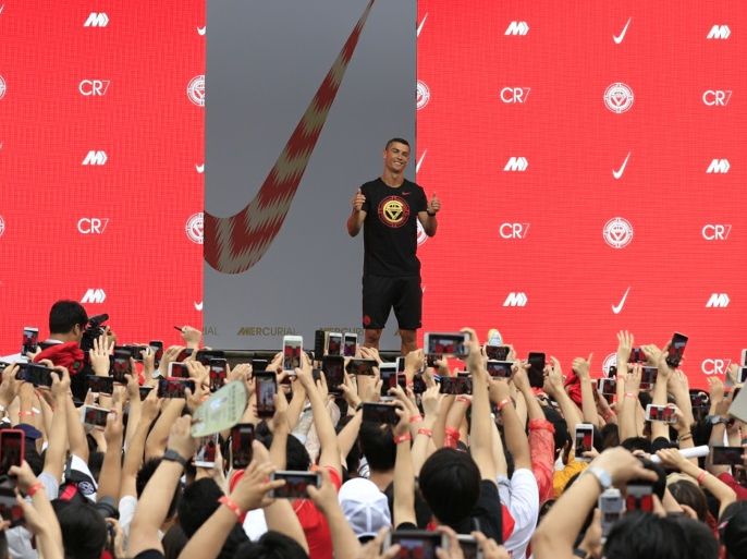 Portuguese soccer player Cristiano Ronaldo gestures as fans take photos of him, during an event held by Nike for his annual CR7 Tour in Beijing, China July 19, 2018. REUTERS/Stringer ATTENTION EDITORS - THIS IMAGE WAS PROVIDED BY A THIRD PARTY. CHINA OUT.