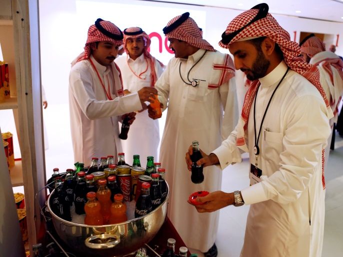 Saudi men buy soft drinks at Saudi Arabia's first commercial movie theater in Riyadh, Saudi Arabia April 18, 2018. REUTERS/Faisal Al Nasser