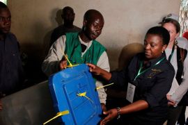 Cecile Kyenge (R), Chief Observer of the European Union election observation mission, holds a ballot box during the presidential election in Bamako, Mali July 29, 2018. REUTERS/Luc gnago