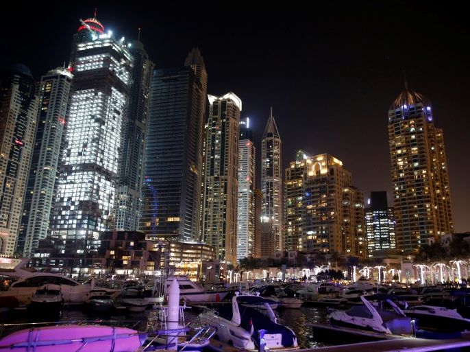 Yachts are seen at a dock at the Dubai Marina surrounded by high towers of hotels, banks and office buildings, in Dubai, United Arab Emirates December 11, 2017. REUTERS/Amr Abdallah Dalsh
