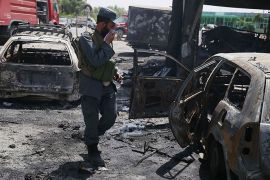 epa06877234 Afghan security officials inspect the scene of a suicide bomb attack that targeted National Directorate of Security (NDS) soldiers in Jalalabad, Afghanistan, 10 July 2018. At least 10 people including 2 NDS soldiers were killed and 4 others were injured in the incident. EPA-EFE/GHULAMULLAH HABIBI