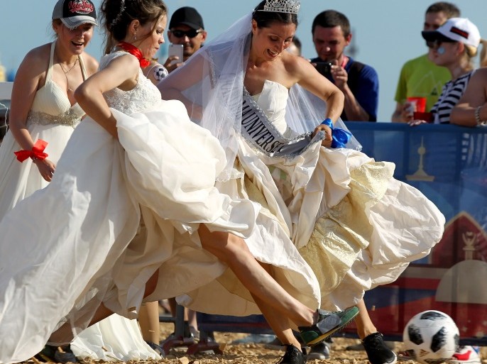 Women wearing wedding dresses take part in the so-called