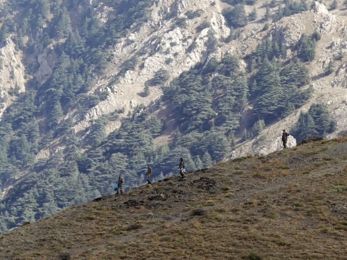 Algerian military soldiers patrol a mountain near the village of Ait Ouabane, where a Frenchman was kidnapped by militants on Sunday, southeast of Algiers September 23, 2014. Algerian military and police set up checkpoints and sent troops into mountains east of Algiers on Tuesday to look for the Frenchman kidnapped by militants who threatened to execute him over France's intervention in Iraq. The Caliphate Soldiers, a splinter group linked to Islamic State militants in