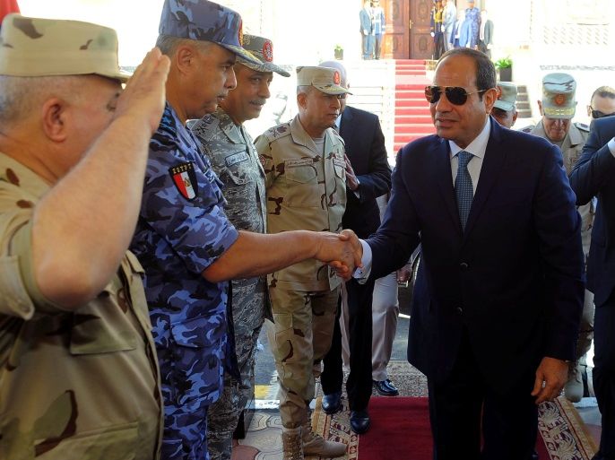 Egyptian President Abdel Fattah al-Sisi (L) chack the hands with Army Generals with Egypt's Minister of Defense Sedki Sobhi (back) during a presentation of combat efficiency and equipment of the armed forces in Suez, Egypt, October 29, 2017 in this handout picture courtesy of the Egyptian Presidency. The Egyptian Presidency/Handout via REUTERS ATTENTION EDITORS - THIS IMAGE WAS PROVIDED BY A THIRD PARTY