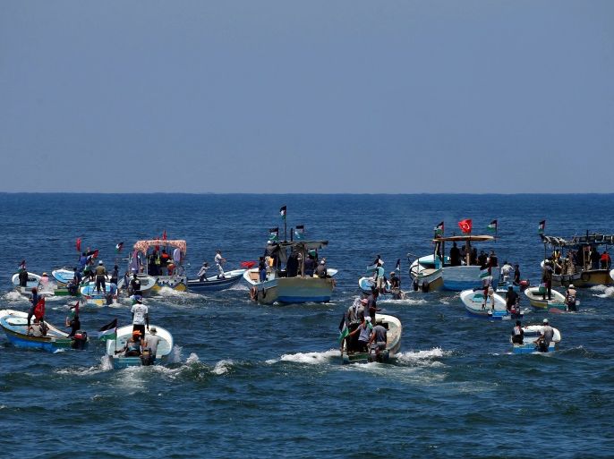People ride boats as a boat carrying Palestinian patients and students sails towards Europe aiming to break Israel's blockade on Gaza, at the sea in Gaza July 10, 2018. REUTERS/Mohammed Salem