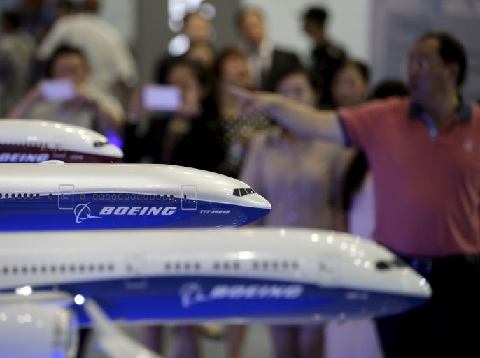 Visitors look at models of Boeing aircrafts at the Aviation Expo China 2015, in Beijing, China, in this September 16, 2015 file photo. REUTERS/Jason Lee/File Photo