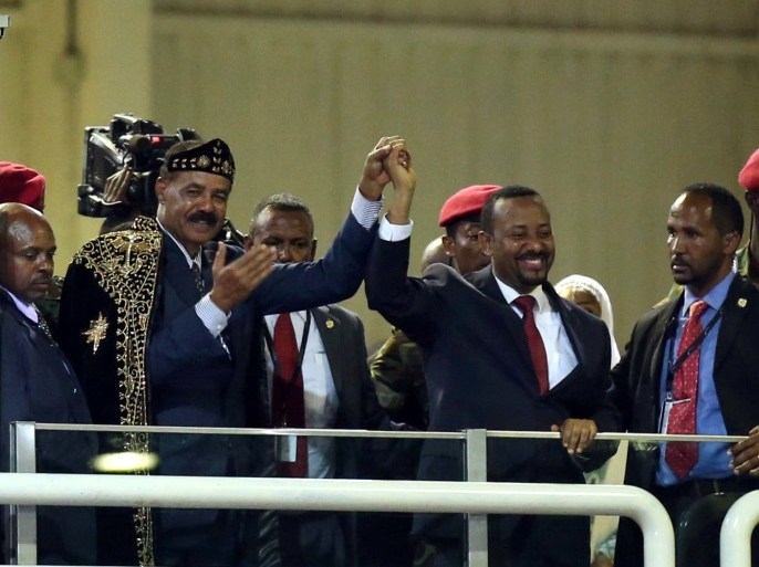 Eritrea's President Isaias Afwerki and Ethiopian Prime Minister Abiy Ahmed hold hands during a concert at the Millennium Hall in Addis Ababa, Ethiopia July 15, 2018. REUTERS/Tiksa Negeri