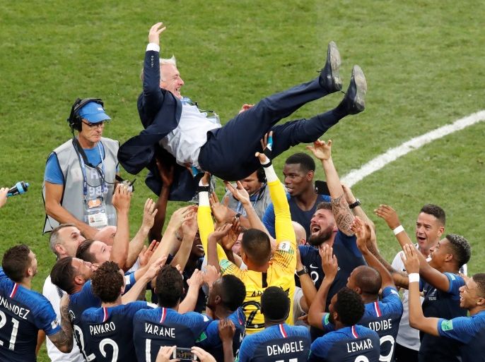 Soccer Football - World Cup - Final - France v Croatia - Luzhniki Stadium, Moscow, Russia - July 15, 2018 France coach Didier Deschamps is held up by players to celebrate winning the World Cup. Christian Hartmann: