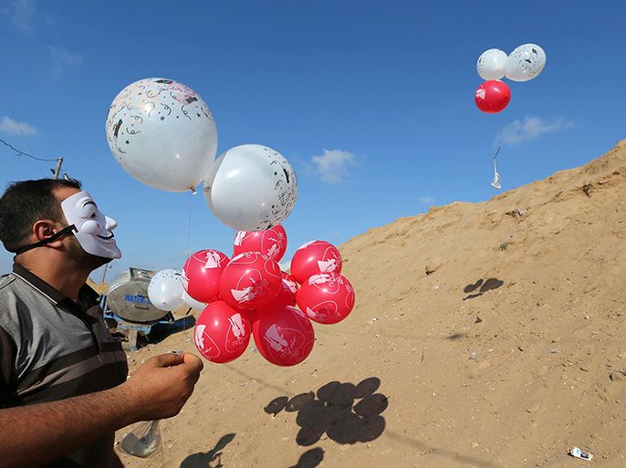 Palestinians fly balloons loaded with flammable material to be thrown at the Israeli side, near the Israel-Gaza border in the central Gaza Strip, June 4, 2018. Picture taken June 4, 2018. REUTERS/Ibraheem Abu Mustafa