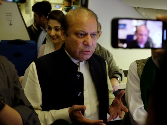Ousted Pakistani Prime Minister Nawaz Sharif gestures as he boards a Lahore-bound flight due for departure, at Abu Dhabi International Airport, UAE July 13, 2018. REUTERS/Drazen Gorgic