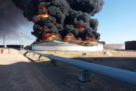 Smoke and flame rise from an oil storage tank that was set on fire amid fighting between rival factions at Ras Lanuf terminal, Libya in this handout picture released on June 18, 2018. The National Oil Corporation/ Handout via Reuters ATTENTION EDITORS - THIS PICTURE WAS PROVIDED BY A THIRD PARTY. REUTERS IS UNABLE TO INDEPENDENTLY VERIFY THIS IMAGE.