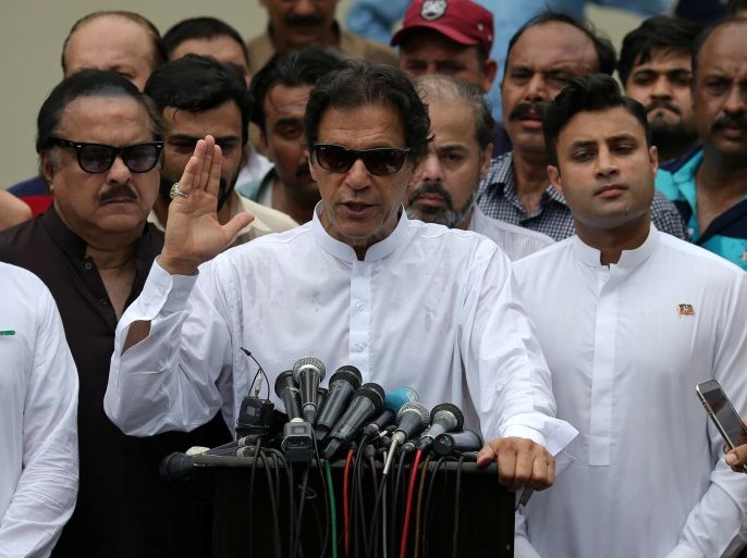 Cricket star-turned-politician Imran Khan, chairman of Pakistan Tehreek-e-Insaf (PTI), speaks to members of media after casting his vote at a polling station during the general election in Islamabad, Pakistan, July 25, 2018. REUTERS/Athit Perawongmetha