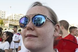 BRIGHTON, ENGLAND - JULY 03: The big screen is reflected in a fans sunglasses as she watches the FIFA 2018 World Cup Finals match between Colombia and England at Luna Beach Cinema on Brighton Beach on July 3, 2018 in Brighton, England. World Cup fever is building among England fans after reaching the Round of 16 in Russia. (Photo by Alan Crowhurst/Getty Images)