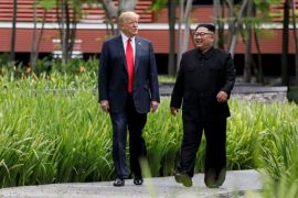 U.S. President Donald Trump and North Korea's leader Kim Jong Un walk together before their working lunch during their summit at the Capella Hotel on the resort island of Sentosa, Singapore June 12, 2018. Picture taken June 12, 2018. REUTERS/Jonathan Ernst