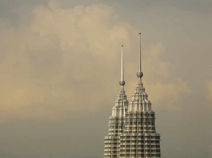 The peaks of the Petronas Twin Towers is seen in central Kuala Lumpur, August 16, 2014. Malaysia's economy grew 6.4 percent in the second quarter, faster than expected, as exports kept up their strong performance and consumer spending stayed buoyant despite steps by the central bank to curb high household debt levels. REUTERS/Olivia Harris (MALAYSIA - Tags: BUSINESS CITYSCAPE)