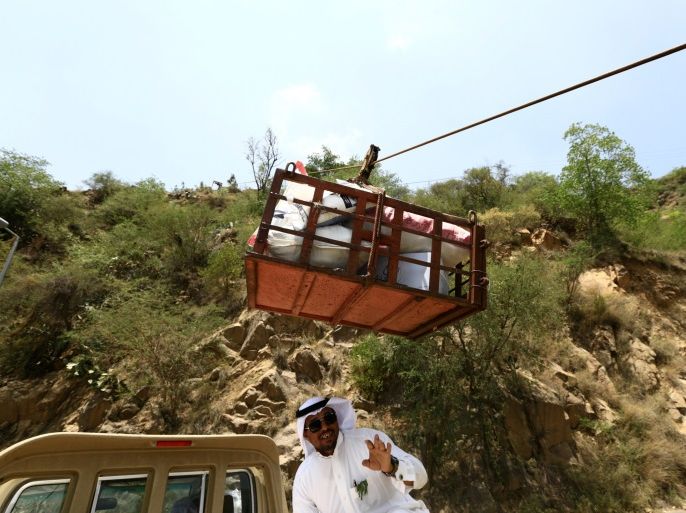 A man uses a makeshift aerial lift to transport goods between Fifa Mountains, in Jazan, south of Saudi Arabia, April 8, 2017. Picture taken April 8, 2017. REUTERS/Mohamed Al Hwaity
