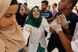 A Palestinian nurse reacts upon seeing the body of her husband who was killed by Israeli troops during a protest at the Israel-Gaza border, in the southern Gaza Strip July 27, 2018. REUTERS/Ibraheem Abu Mustafa