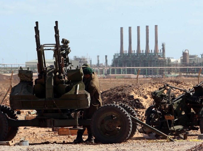 epa05847199 (FILE) - A Libyan rebel mans an anti-aircraft gun near the Ras Lanuf oil refinery (background) in Ras Lanuf, eastern Libya, 06 March 2011 (reissued 14 March 2017). According to media reports on 14 March 2017, Libyan forces loyal to General Khalifa Haftar, chief of the Libyan National Army, began an operation to recapture the oil port of Ras Lanuf from a Benghazi militia. The Islamist Benghazi militia earlier this month took control of al-Sidra, Libya’s bigge
