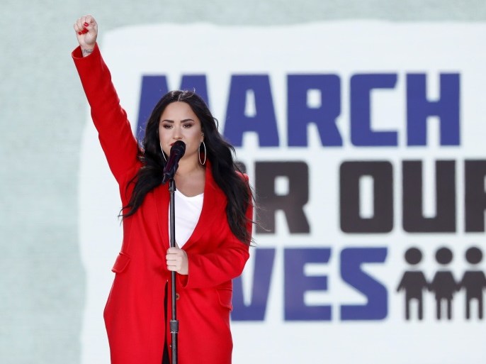 Singer Demi Lovato salutes the crowd after performing the song