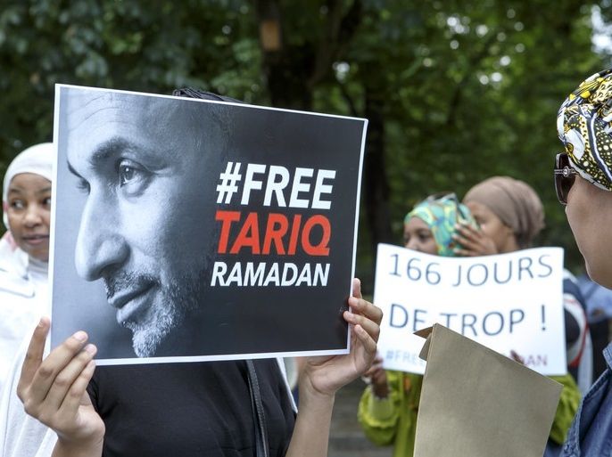 06894603 Women hold placards with writing 'Free Tariq Ramadan' and '166 days too much!', during a rally in support of Islamic scholar Tariq Ramadan, in front of French consulate in Geneva, Switzerland, 17 July 2018. Tariq Ramadan is detained in France on alleged sexual harassment and rape charges. Ramadan is detained for questioning in Paris, months after women filed rape charges or sexual assault against him in France. Ramadan has denied the allegations. EPA-EFE/SA