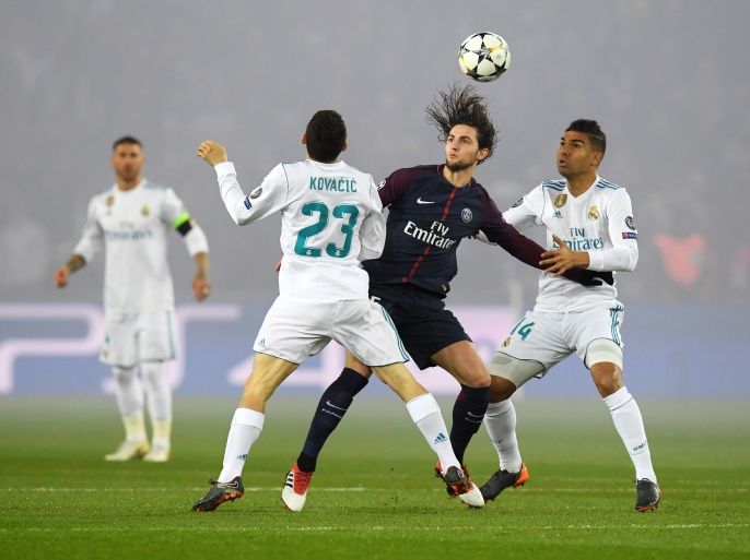 PARIS, FRANCE - MARCH 06: Adrien Rabiot of PSG battles with Mateo Kovacic and Casemiro of Real Madrid during the UEFA Champions League Round of 16 Second Leg match between Paris Saint-Germain and Real Madrid at Parc des Princes on March 6, 2018 in Paris, France. (Photo by Matthias Hangst/Getty Images)