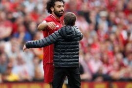 Soccer Football - Premier League - Liverpool v West Ham United - Anfield, Liverpool, Britain - August 12, 2018 Liverpool's Mohamed Salah with a young pitch invader Action Images via Reuters/Carl Recine EDITORIAL USE ONLY. No use with unauthorized audio, video, data, fixture lists, club/league logos or
