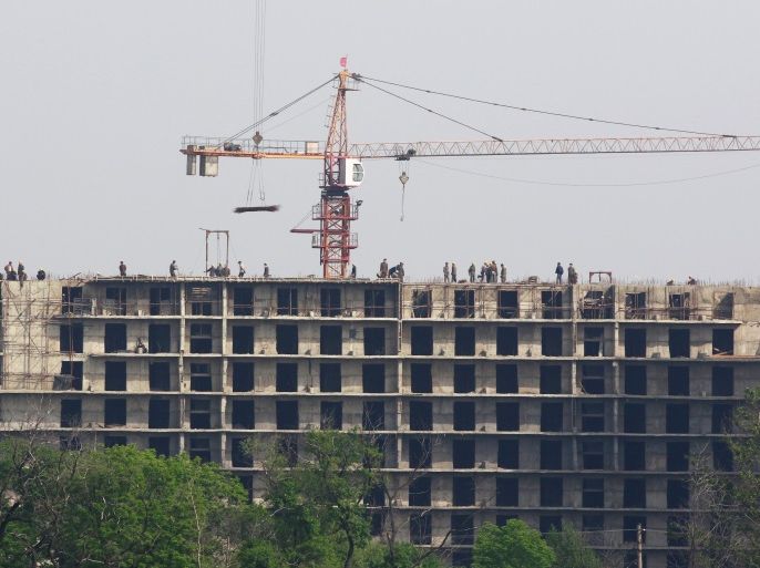 Workers at the construction site of a building in Sinuiju, North Korea are seen from Dandong, Liaoning province, China May 24, 2018. Picture taken May 24, 2018. REUTERS/Jacky Chen