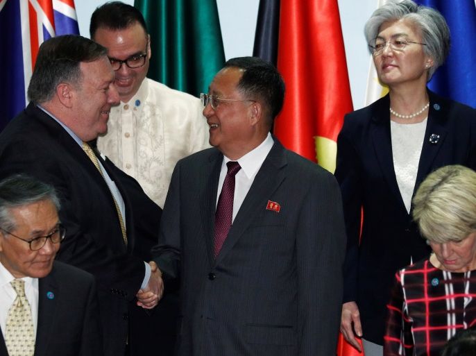 U.S. Secretary of State Mike Pompeo shakes hands with North Korea's Foreign Minister Ri Yong Ho as South Korea's Foreign Minister Kang Kyung-wha looks on at the Asean Regional Forum Retreat Session in Singapore August 4, 2018. REUTERS/Edgar Su