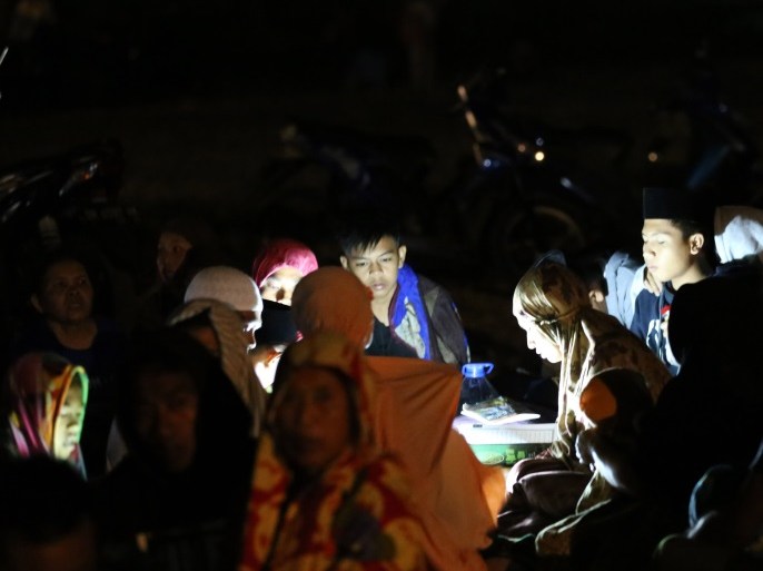 Residents read the Koran during aftershocks at Duman Village in Lombok, West Nusa Tenggara, Indonesia, 05 August 2018. Reports state that the magnitude 7.0 earthquake was centered on the Indonesian island of Lombok nearby of Bali. EPA-EFE/STR